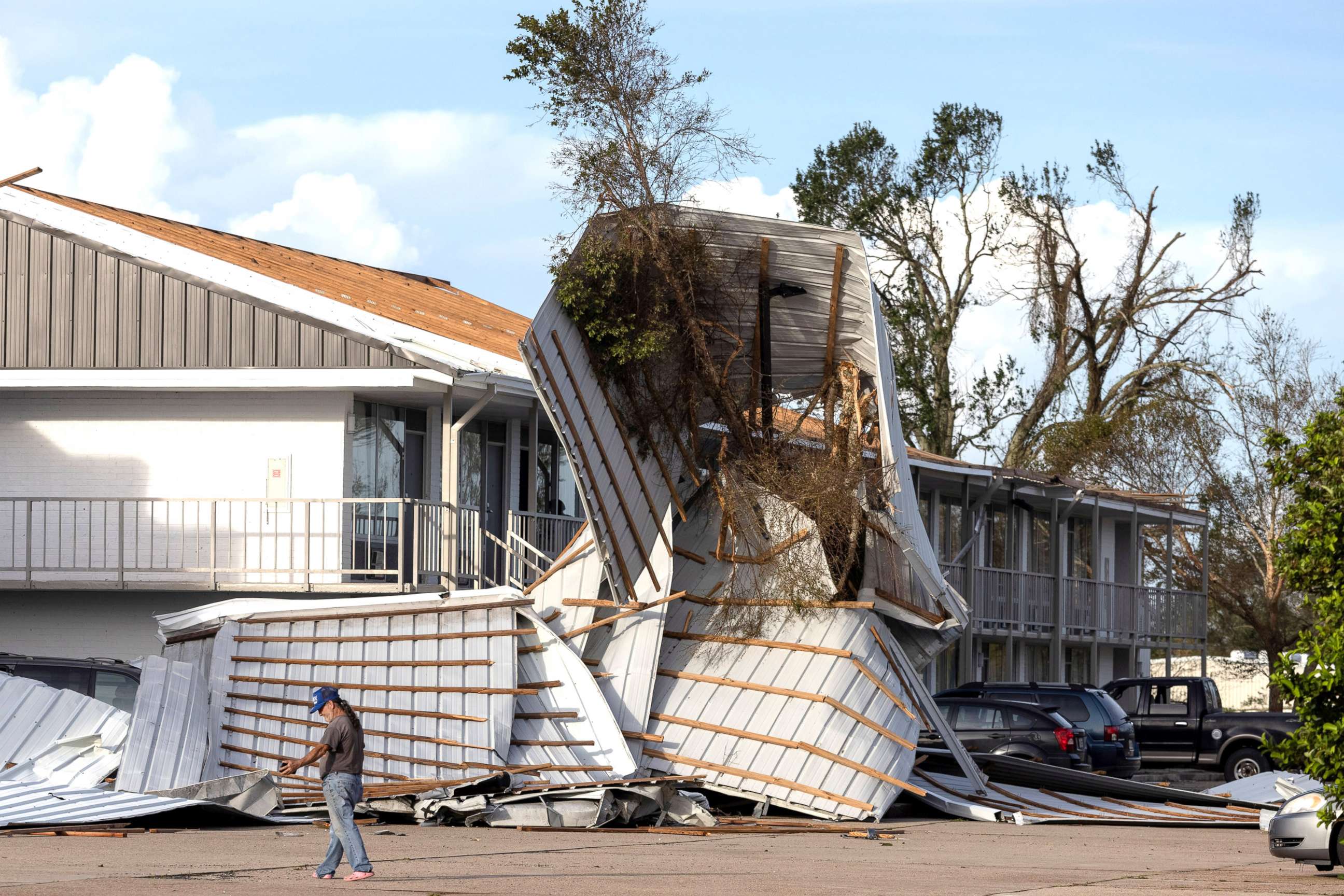 PHOTO: A local resident walks past destruction outside a hotel in the aftermath of Hurricane Ida in Houma, La., Aug. 30, 2021.
