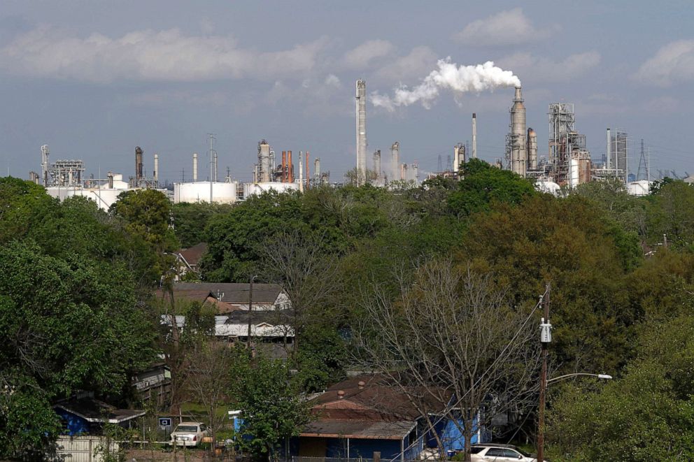 PHOTO: In this March 23, 2020, file photo, homes are seen with The Valero Houston Refinery in the background in Houston.