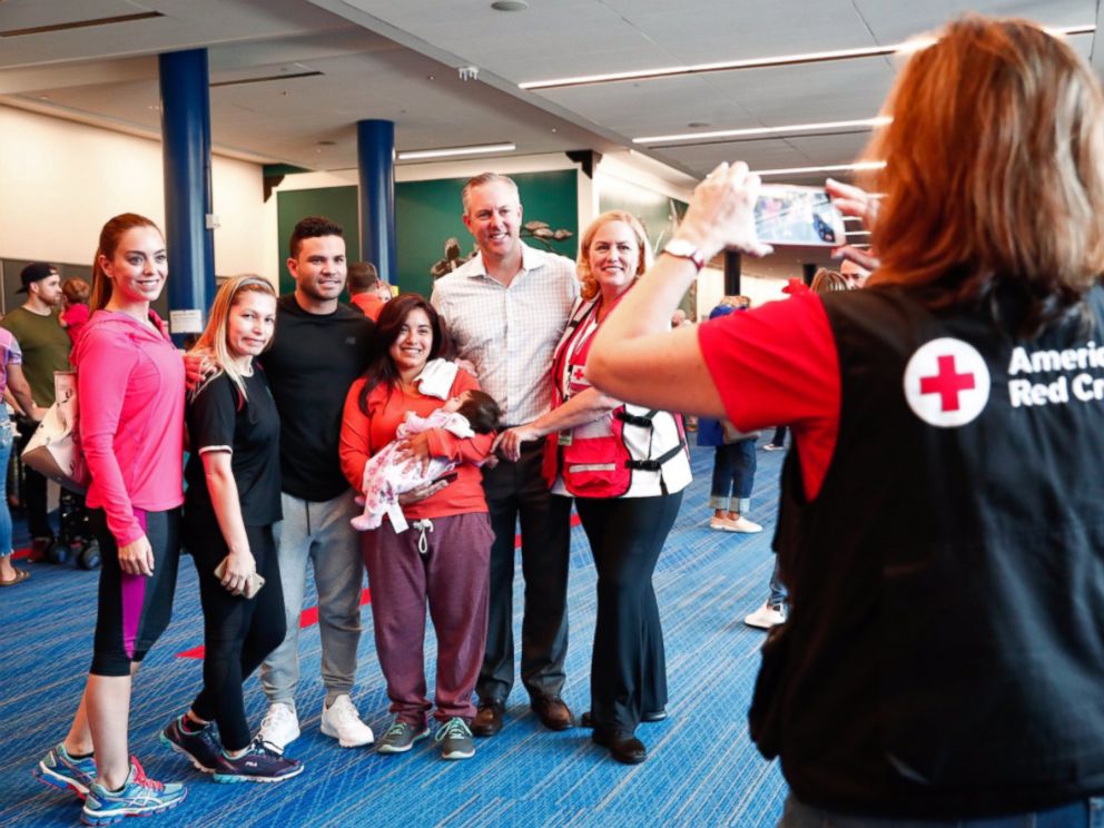 PHOTO: Astros members pose with a group of people in the George R. Brown Convention Center in a photo posted to the teams Twitter account on Sept. 1, 2017.