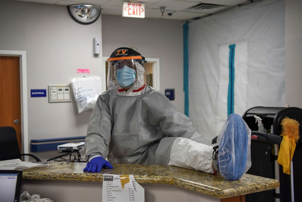 PHOTO: Dr. Joseph Varon, the chief medical officer at United Memorial Medical Center wears personal protective equipment as he stretches his legs before treating COVID-19 patients at UMMC in Houston, Texas, July 25, 2020.