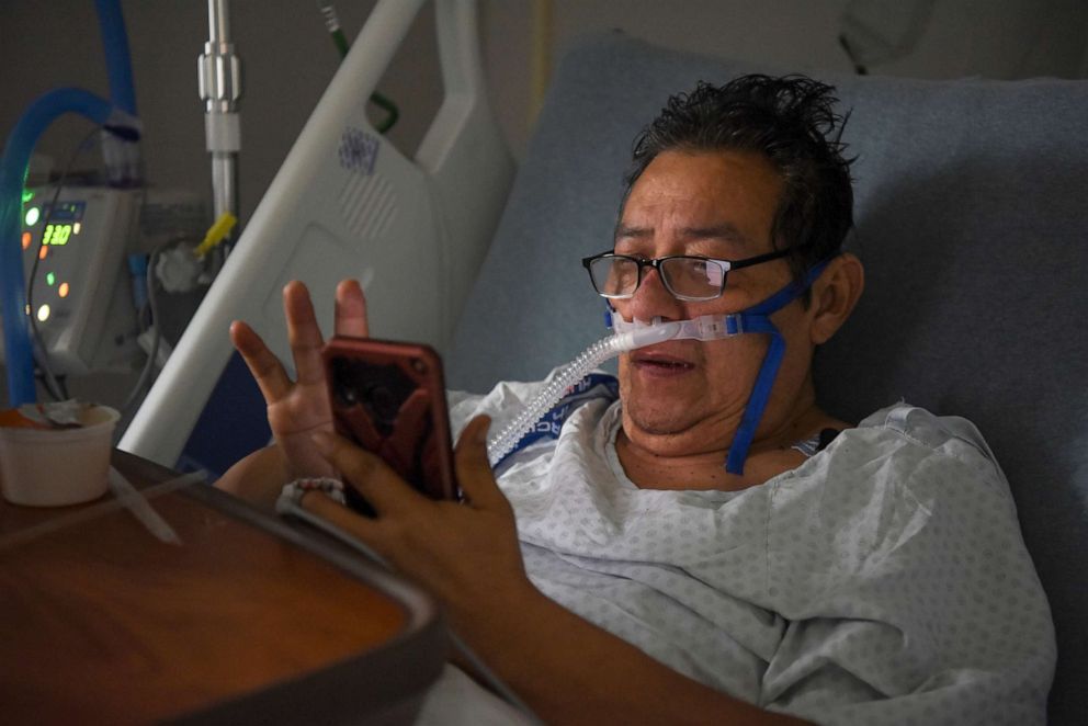 PHOTO: Hector Ortiz-Garcia, 63, who has been hospitalised with COVID-19, texts members of his family from his hospital bed at United Memorial Medical Center (UMMC), during the coronavirus disease (COVID-19) outbreak, in Houston, Texas, July 25, 2020.