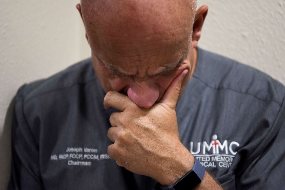 PHOTO: Dr. Joseph Varon, 58, the chief medical officer at United Memorial Medical Center (UMMC), checks his phone after getting home from work, during the coronavirus disease (COVID-19) outbreak,  in Houston, Texas, July 20, 2020.