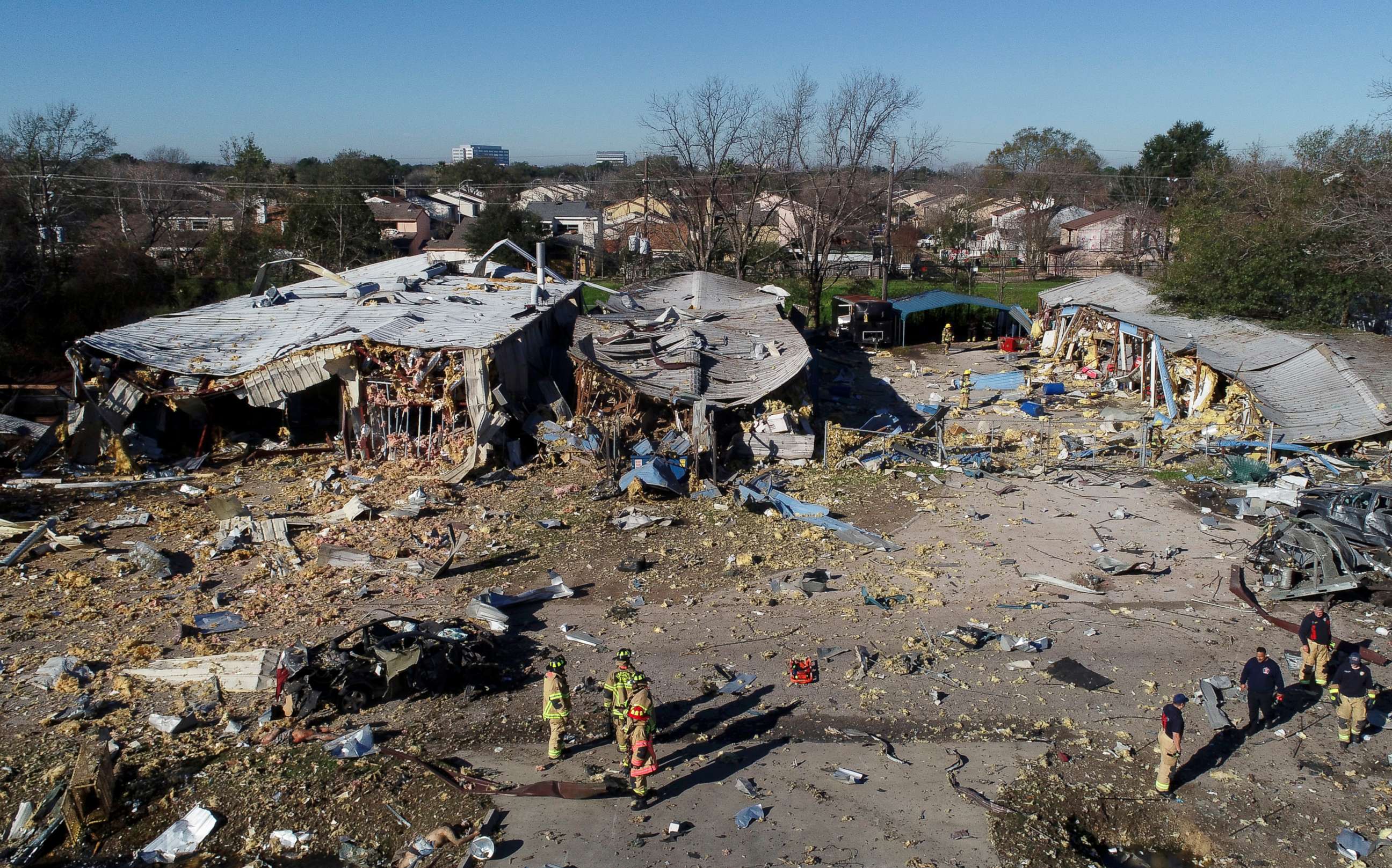 PHOTO: Houston firefighters make their way through debris near the site of an explosion in Houston, Jan. 24, 2020.