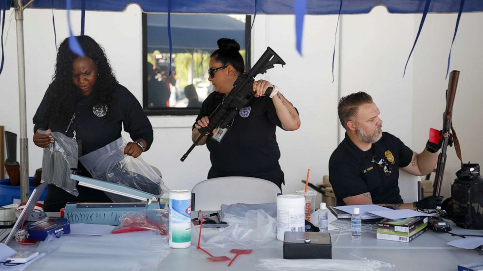 PHOTO: Police officers collect guns during a buyback program in Miami, June 18, 2022. 