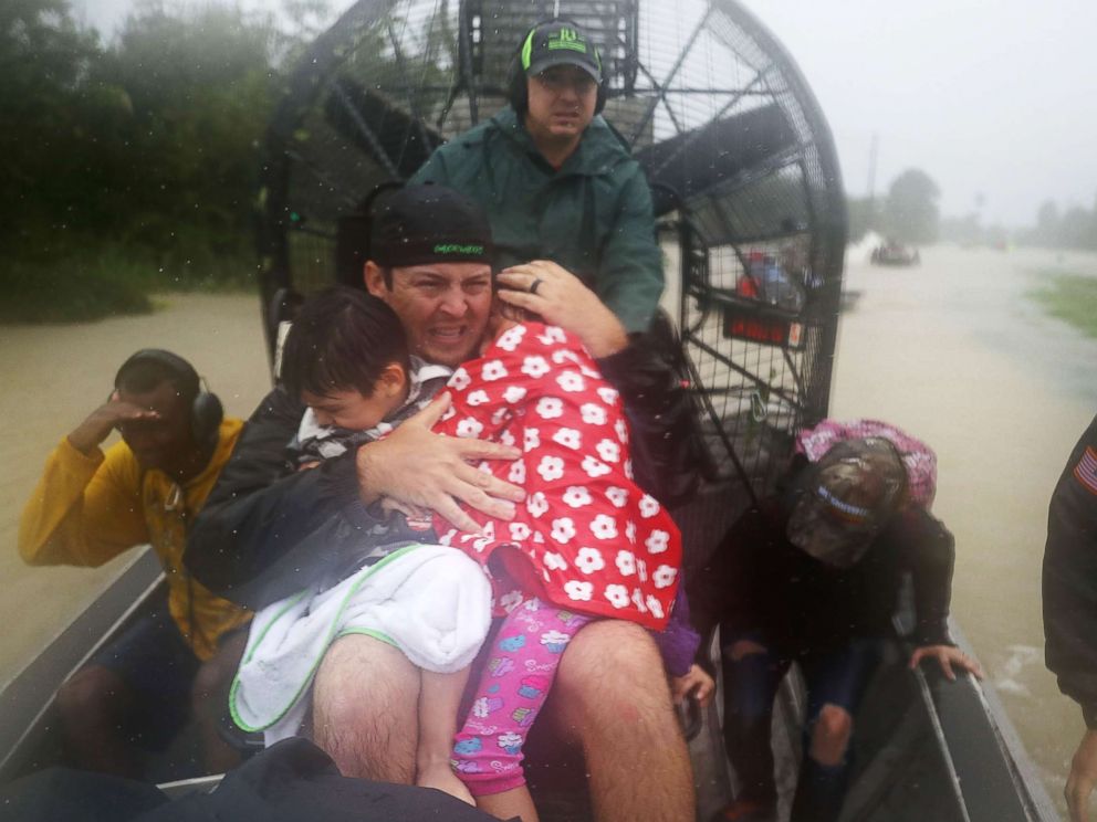 PHOTO: Rescuers use an airboat to rescue people from homes that are inundated with flooding from Hurricane Harvey on Aug. 28, 2017 in Houston.