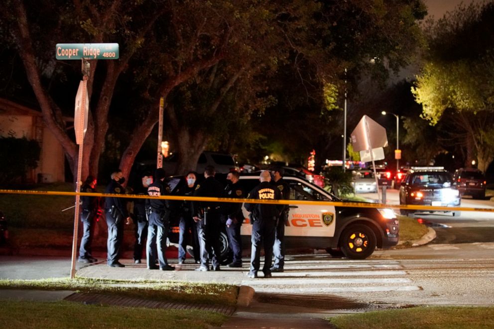 PHOTO: Law enforcement gather near a home where they were investigating a possible human smuggling operation, Thursday night, Dec. 4, 2020, in Houston.
