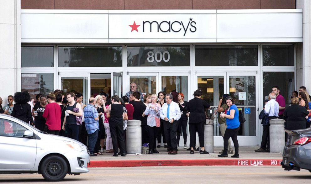 PHOTO: In this Sunday, Aug. 11, 2019, photo, people stand outside Memorial City Mall in Houston, as police investigate a disturbance causing an evacuation of the shopping center.