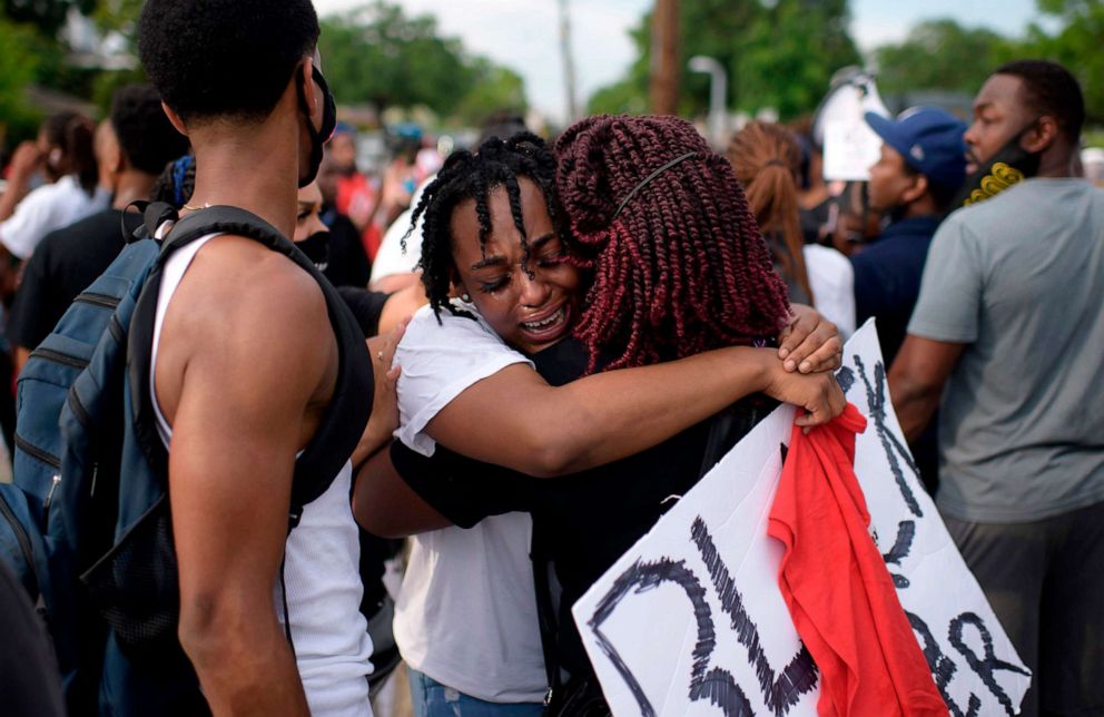 PHOTO: George Floyd's niece Gabrielle Thompson, center, cries as she hugs another woman during a "Justice for George Floyd" event in Houston, May 30, 2020.
