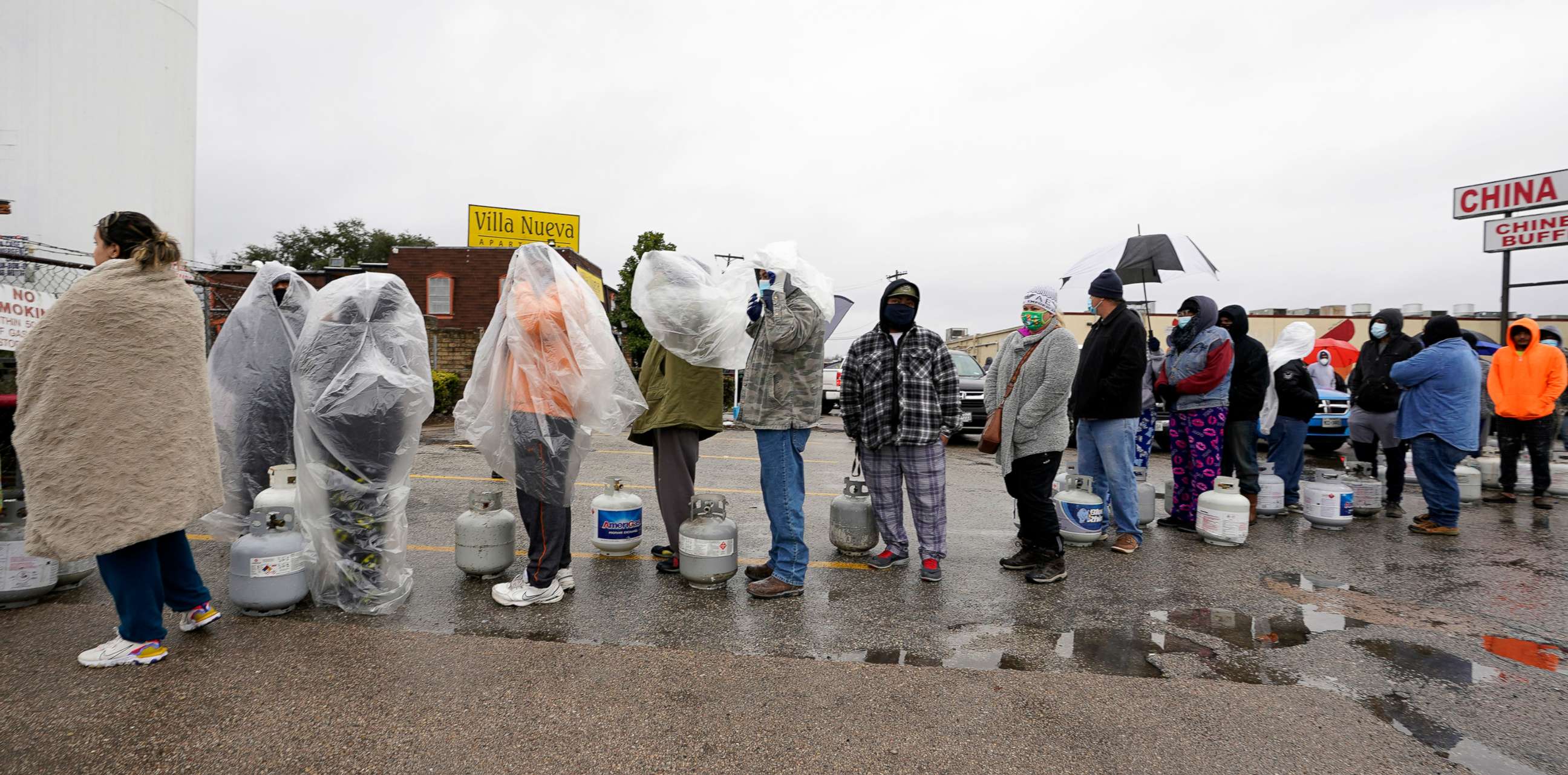 PHOTO: People wait in line to fill propane tanks, Feb. 17, 2021, during widespread power outages after a winter storm in Houston.