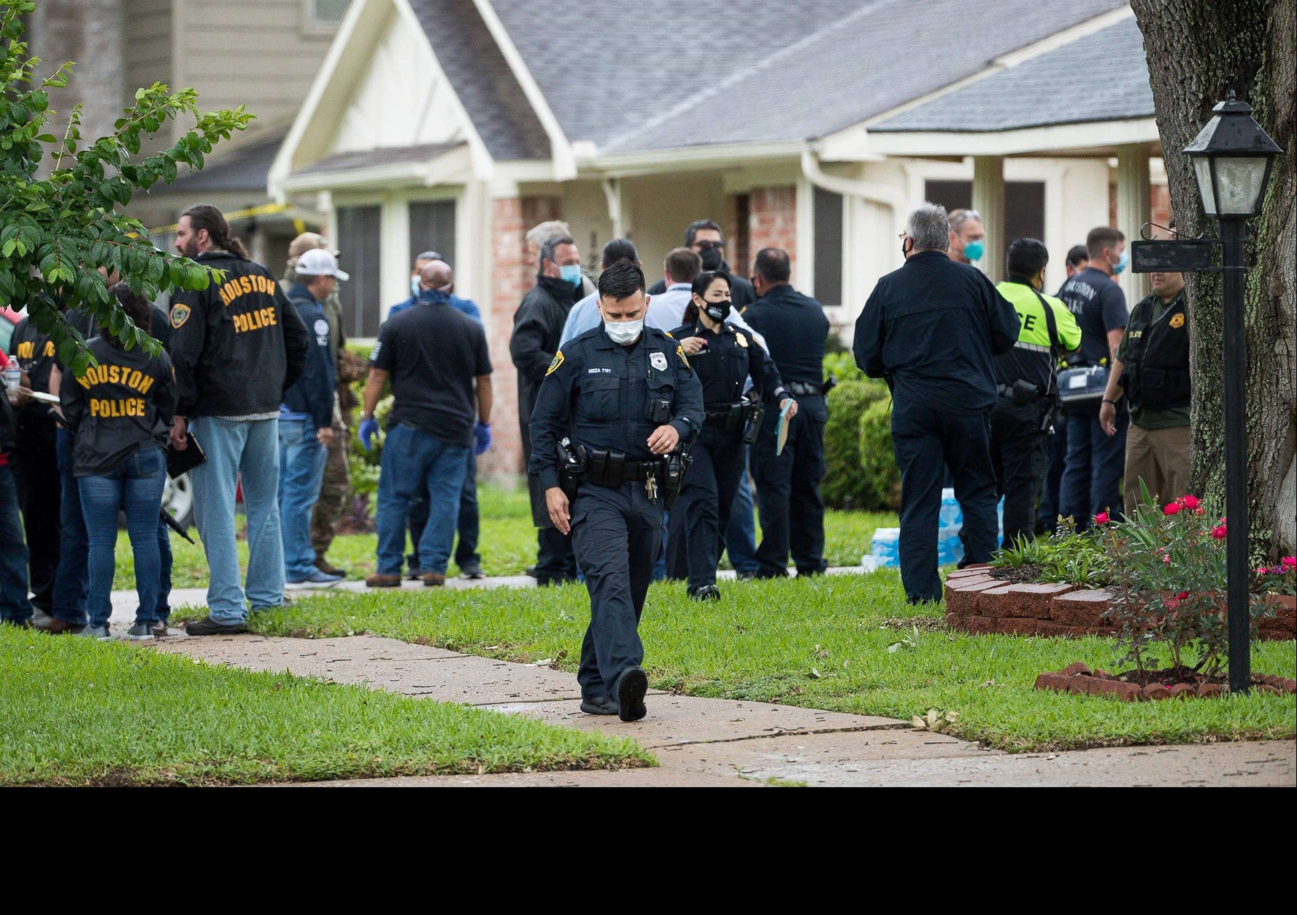PHOTO: Police and first responders gather outside a home in Houston where officials say more than 90 people were found "huddled together" in a possible case of human smuggling, April 30, 2021.