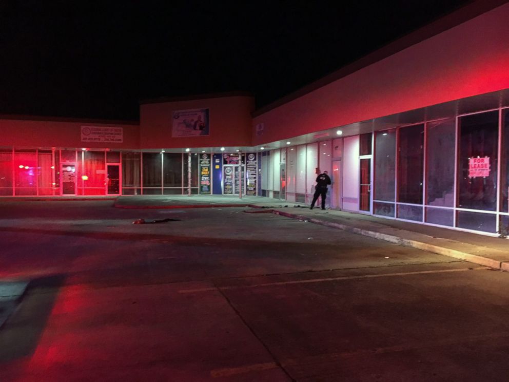 PHOTO: A police officer searches for evidence at the Star Plaza strip mall where the Houston Police say a homeless woman was set on fire on March 5, 2019, by an unknown assailant.