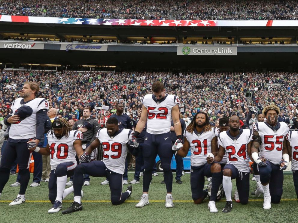 PHOTO: Houston Texans players kneel and stand during the singing of the national anthem before an NFL football game against the Seattle Seahawks, Oct. 29, 2017, in Seattle.
