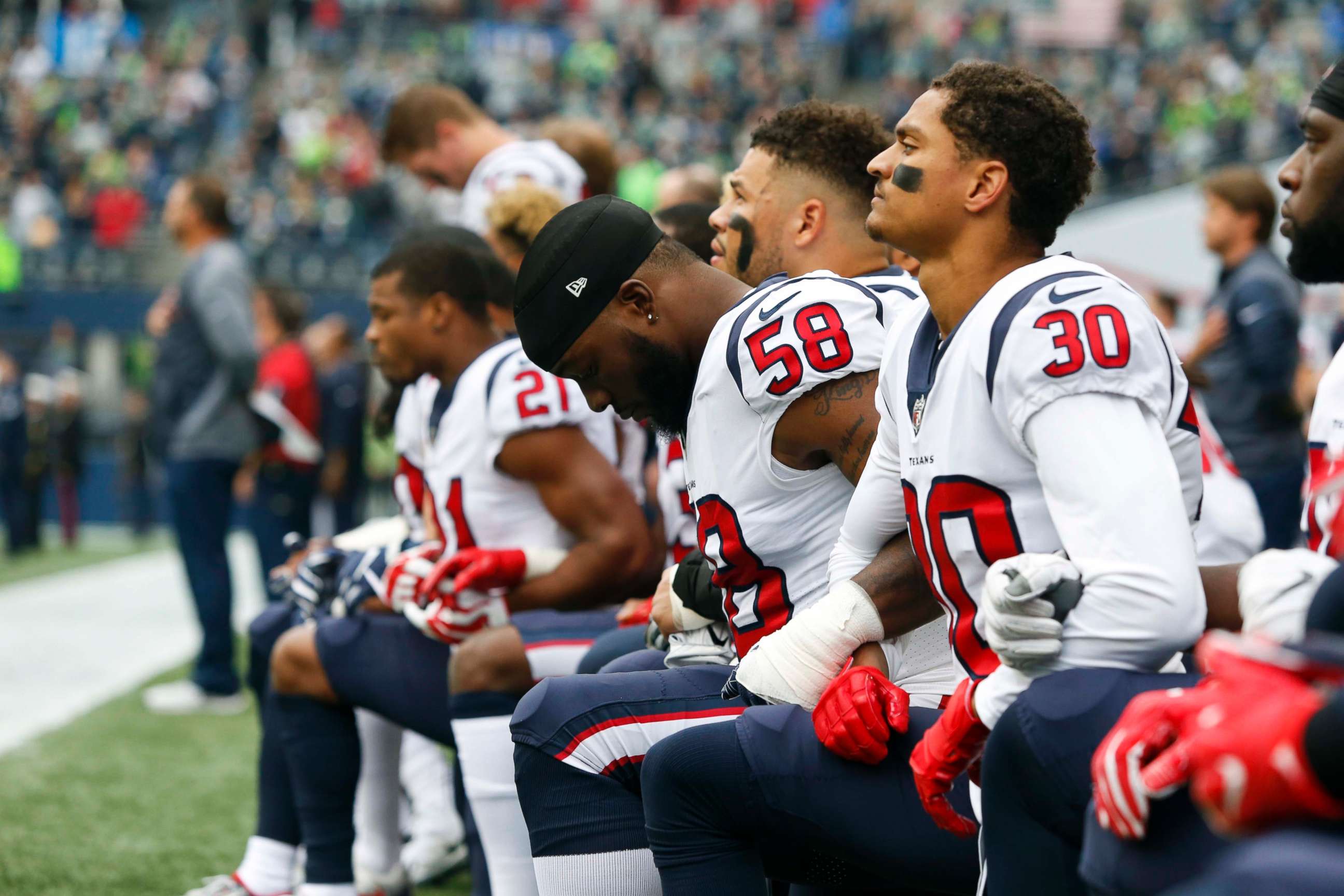 PHOTO: Houston Texans linebacker Lamarr Houston and cornerback Kevin Johnson kneel during the national anthem before kickoff against the Seattle Seahawks at CenturyLink Field in Seattle, Oct. 29, 2017.