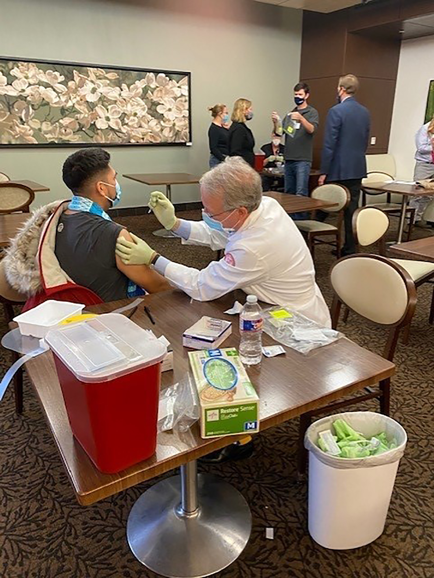 PHOTO: Dr. Marc Boom, President & CEO of Houston Methodist, helps administer 1,000 Moderna Covid-19 vaccines received from Harris County following a freezer breakdown in the middle of a winter storm in Houston, Feb. 15, 2021.