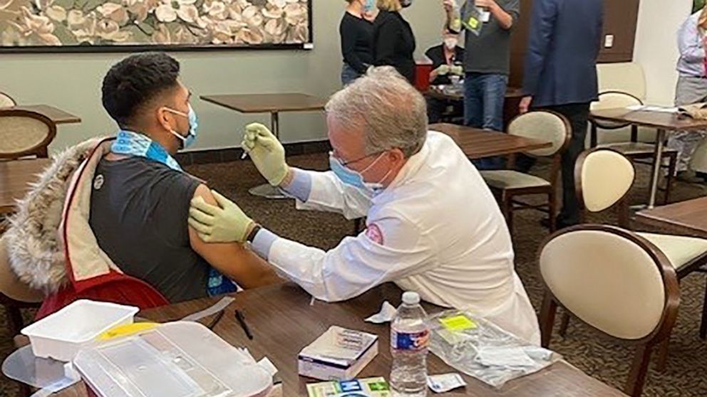 PHOTO: Dr. Marc Boom, President & CEO of Houston Methodist, helps administer 1,000 Moderna Covid-19 vaccines received from Harris County following a freezer breakdown in the middle of a winter storm in Houston, Feb. 15, 2021.