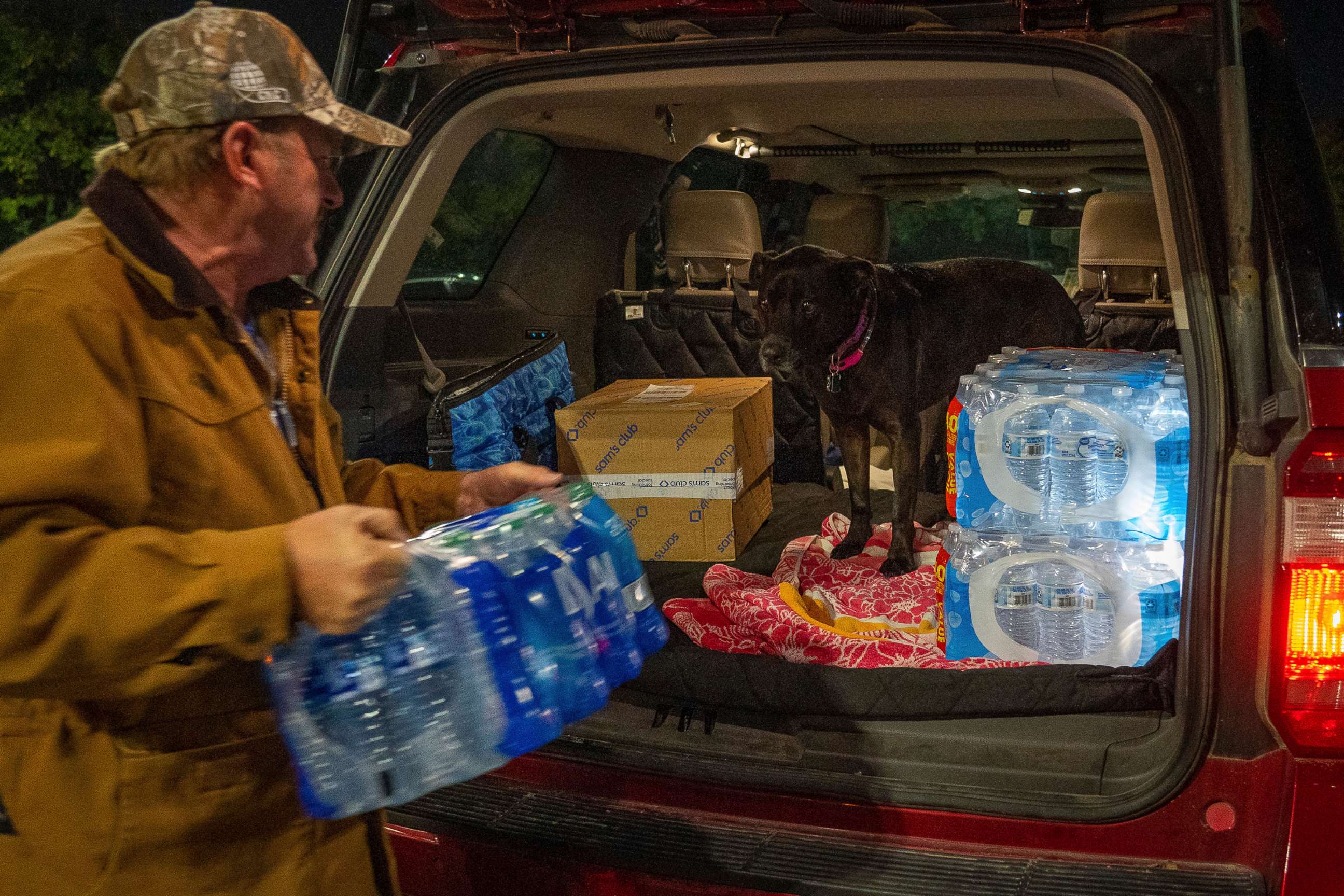 PHOTO: John Beezley, of Bonham, loads several cases of water after learning that a boil water notice was issued for the entire city of Houston, Nov. 27, 2022.