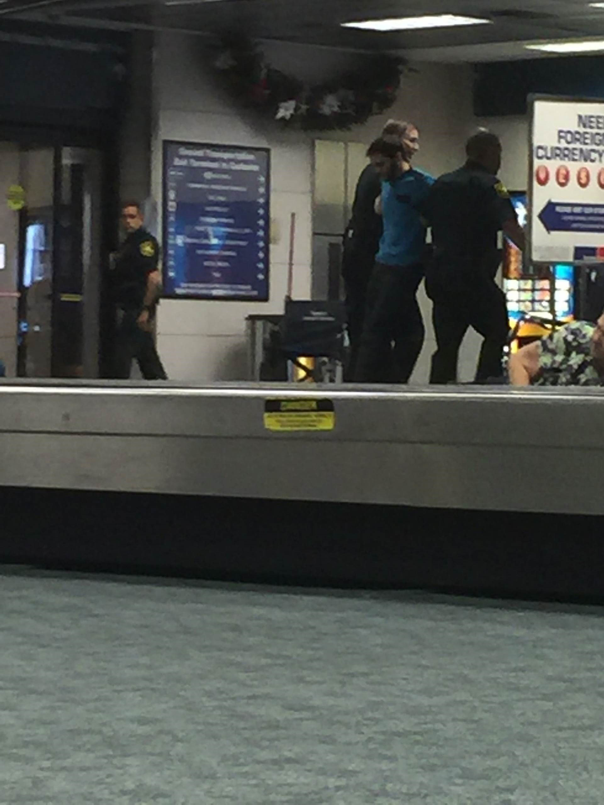 PHOTO: A man identified by an eyewitness as the suspected shooter is led away by law enforcement after a deadly shooting at the Fort Lauderdale airport, Jan. 6, 2017.