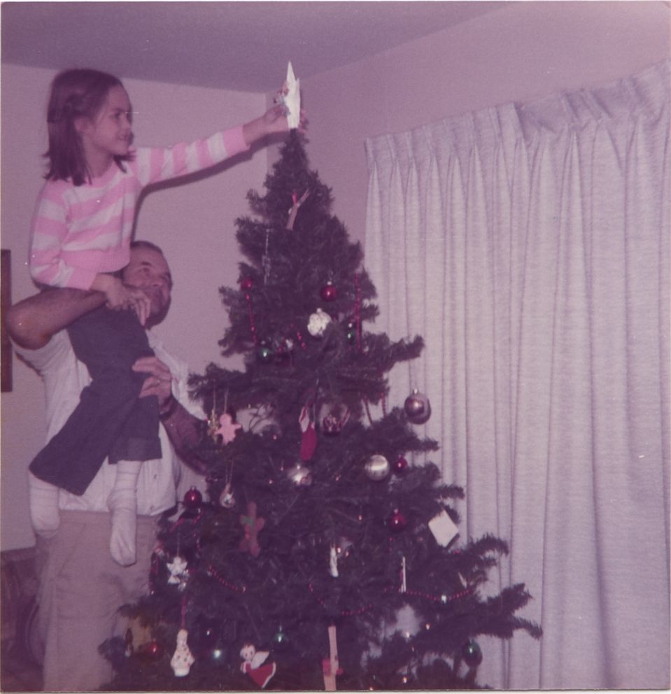 In this family photo, Dennis Rader lifts his daughter Kerri Rawson up to place the star on top of the family Christmas tree, Dec. 1984. 