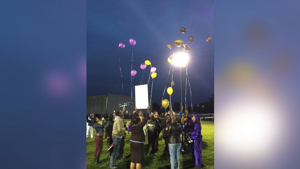 PHOTO:  Aaron Dunigan's family and teammates release balloons in his honor on graduation night.