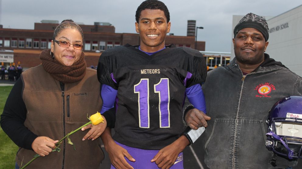 PHOTO: Aaron Dunigan with his mother and father at senior day.