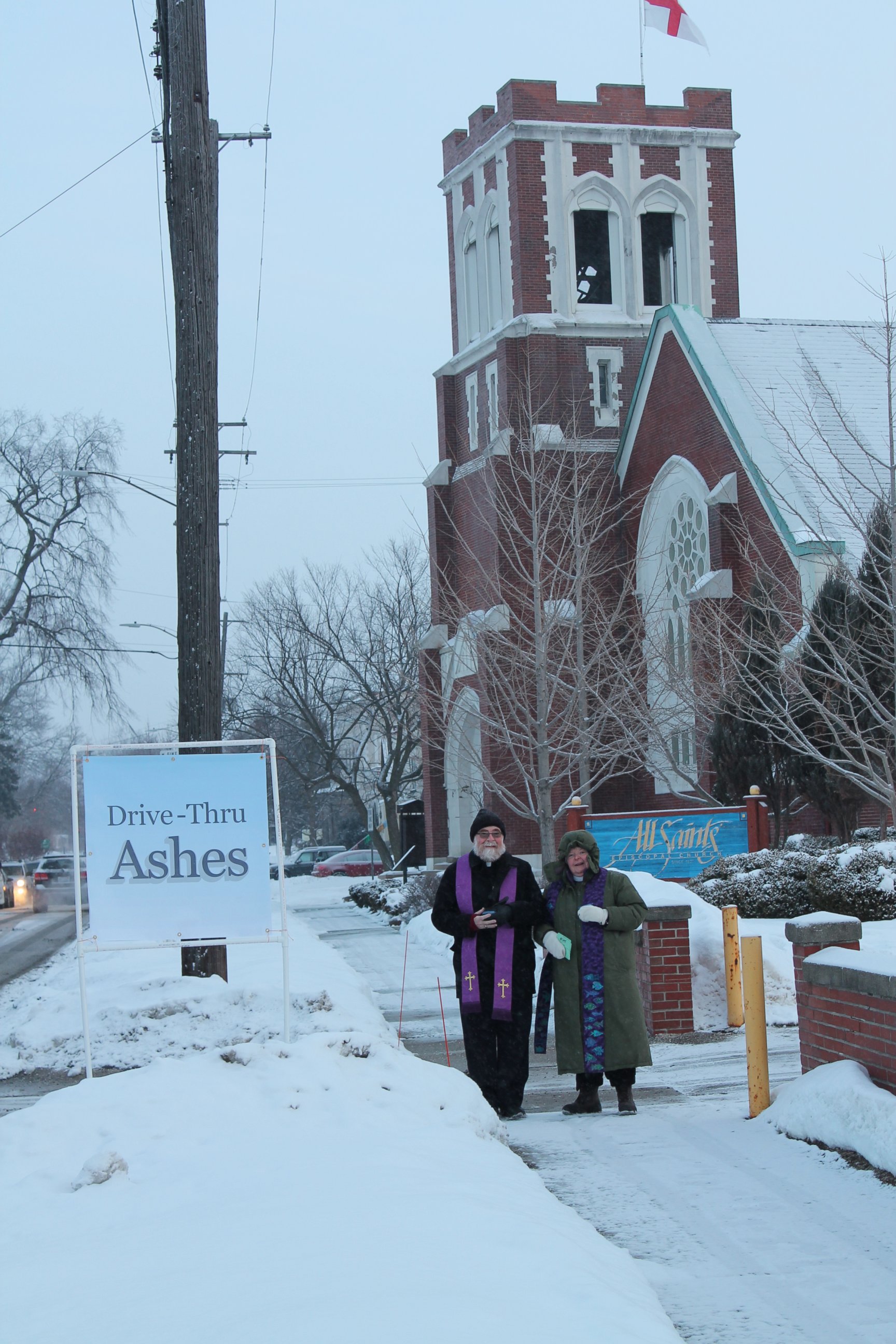 PHOTO: The Reverend Linda Northcraft, the Reverend Chris Berg and volunteers braved a temperature of 9 degrees to place ashes on about 40 participants.
