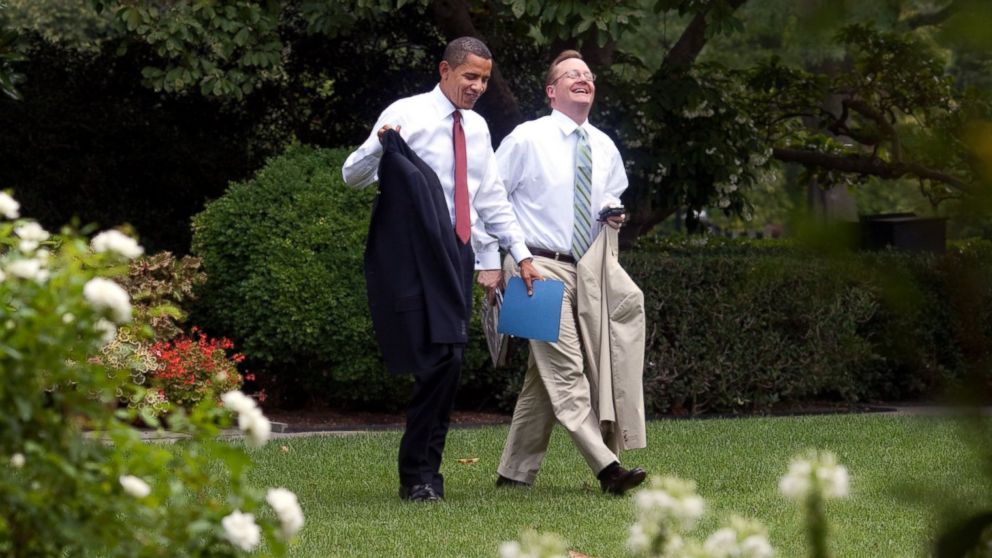 President Barack Obama and Press Secretary Robert Gibbs walk through the Rose Garden back to the Oval Office after the outdoor senior staff meeting in Washington, Aug. 12, 2009. 