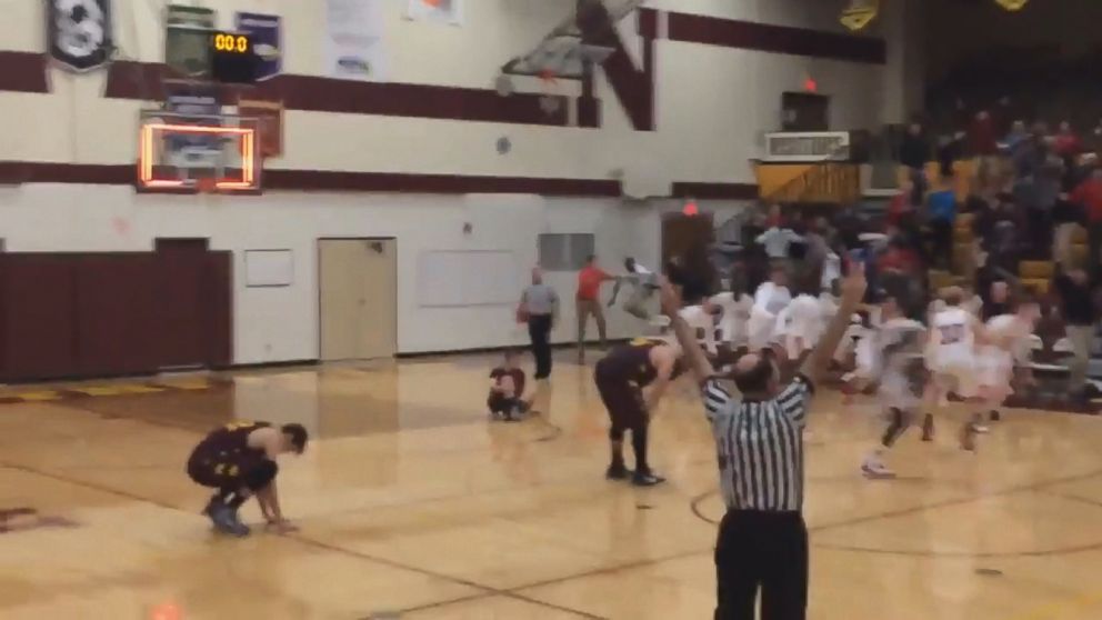 PHOTO: Basketball player Oman Oman for Austin High School in Austin, Minnesota scored a shot made from the other side of the court just before end-of-game buzzer rang on Dec. 8, 2015. 