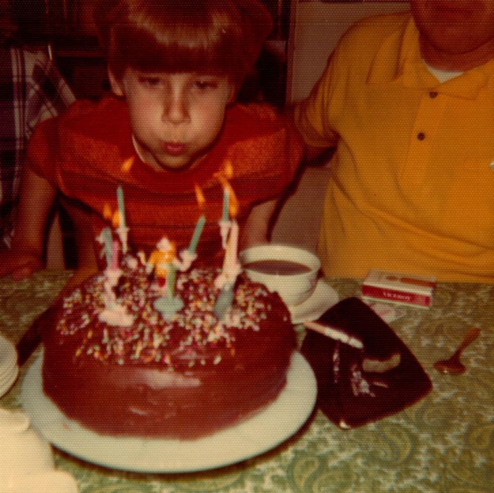 Bill Gillespie is seen here blowing out birthday candles in this 1972 family photo. 
