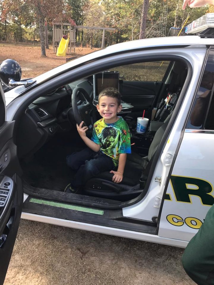 PHOTO: A Walton County, Florida, boy sits in a police cruiser after calling 911 to invite police officers to Thanksgiving Dinner. 