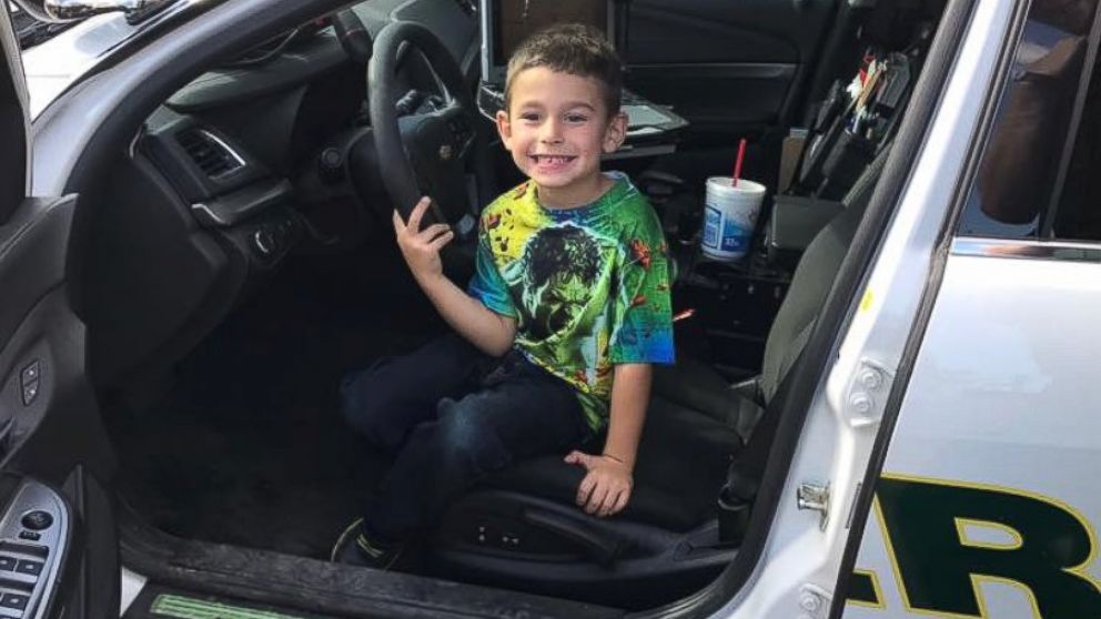 PHOTO: A Walton County, Florida, boy sits in a police cruiser after calling 911 to invite police officers to Thanksgiving Dinner.