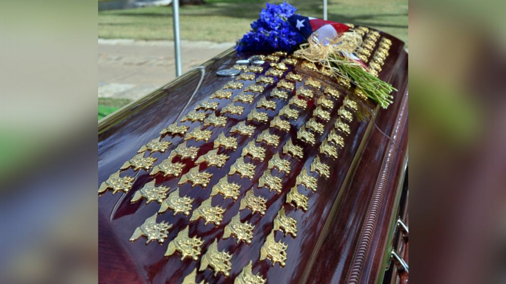 PHOTO: Fellow Navy SEALs placed their tridents on Chris Kyle's casket during his funeral at Texas State Cemetery in Austin, Texas.