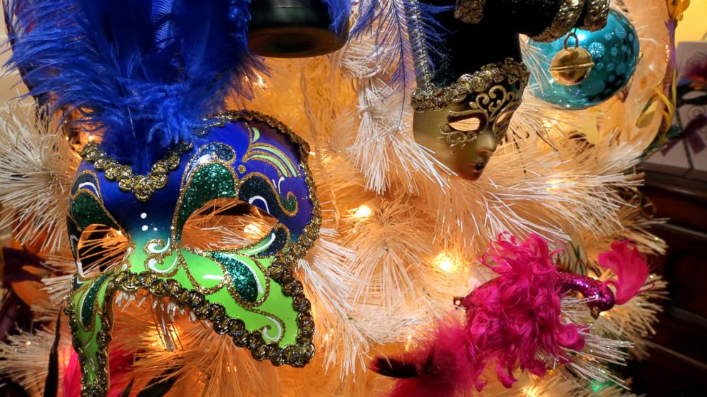 A close up of a christmas tree with a mask on it. Mardi gras tree