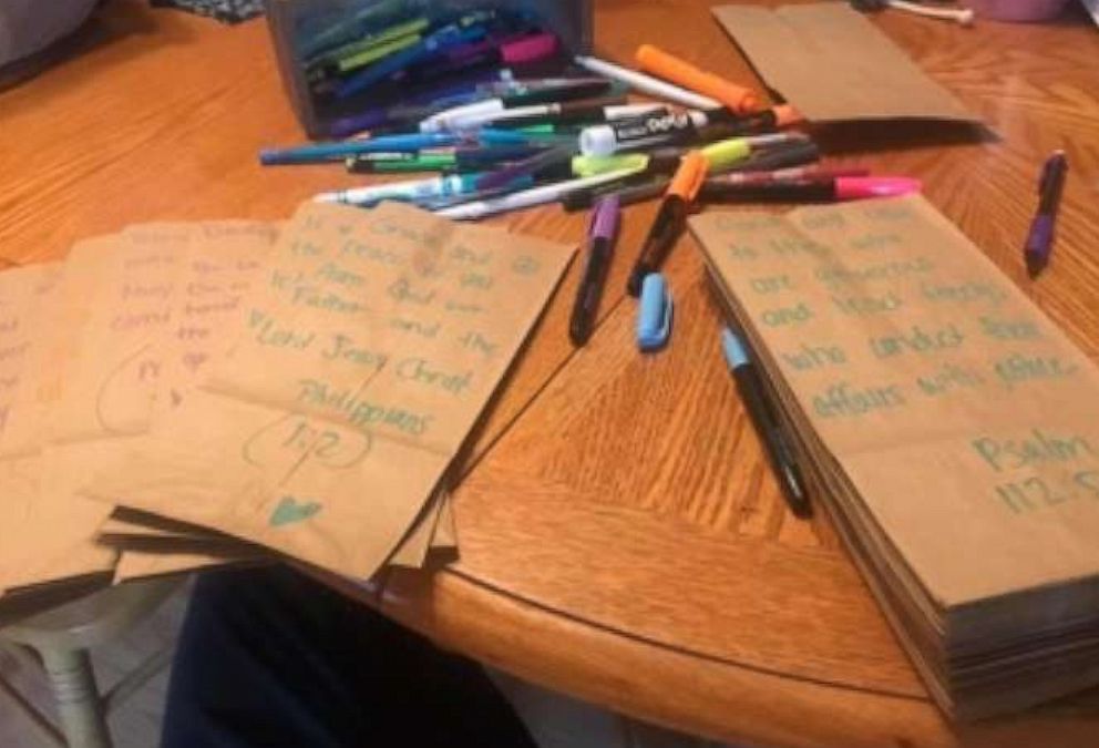 Wendy Reynolds writes messages on paper bags she uses for the sack lunches she gives to the homeless.
