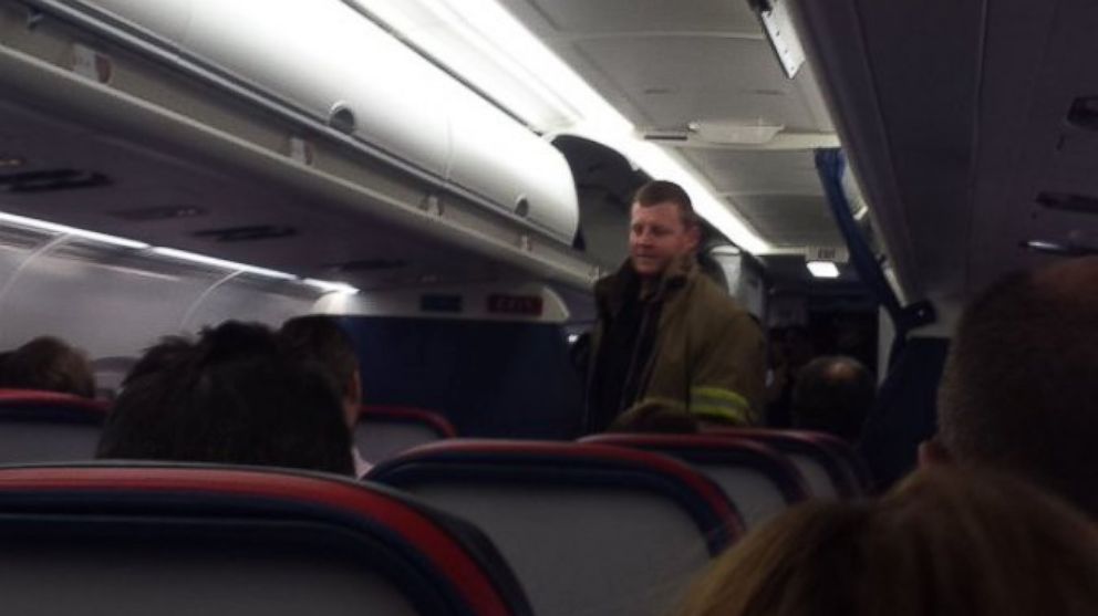 PHOTO: A passenger tweeted this photo of a firefighter while onboard Delta flight 689 on March 16, 2016. The flight was delayed after an electronic cigarette ignited in a passenger's carry-on. 