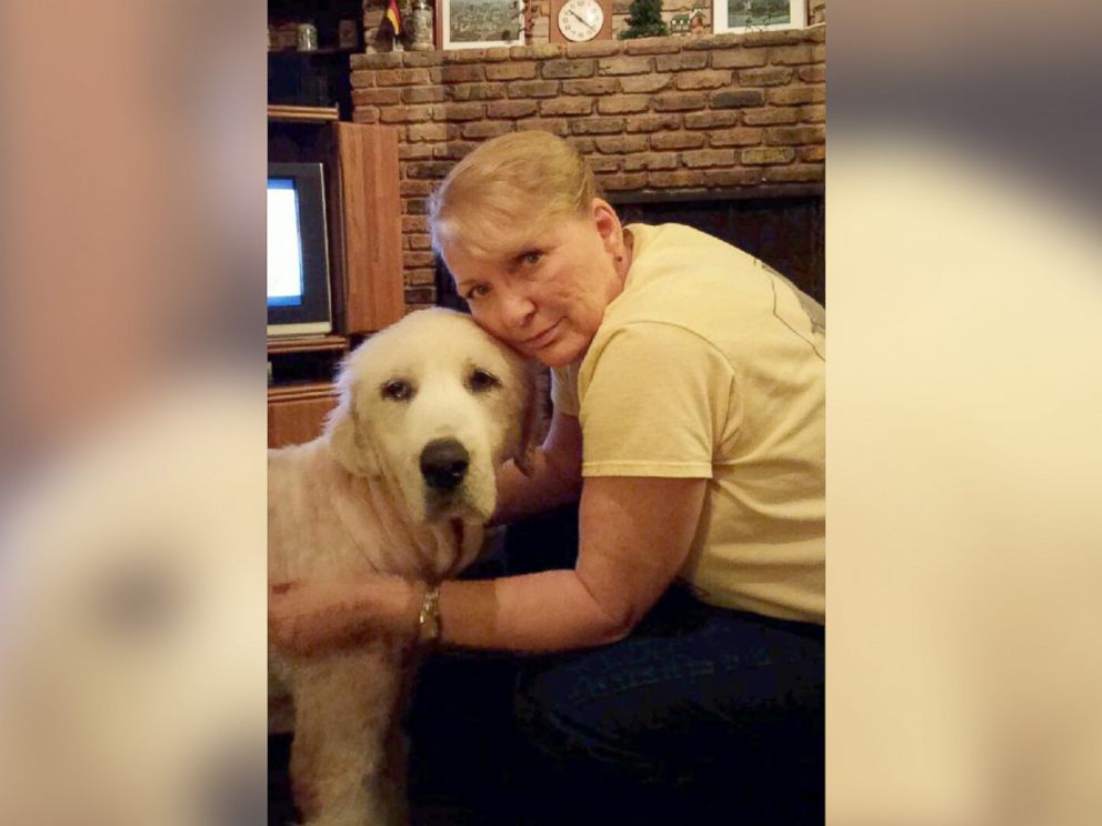 PHOTO: Jo Shockley poses with Emma on the night of May 18, showing how the dog has had her hair shaved so that the veterinarian can treat her wounds. 