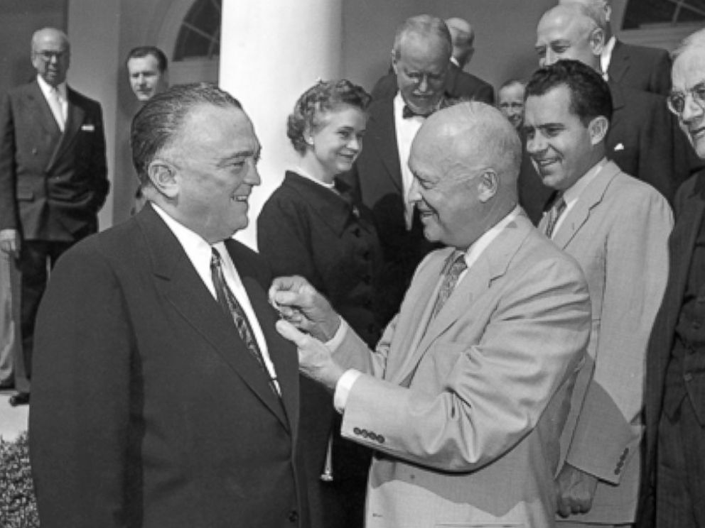Director Hoover receives the National Security Medal from President Dwight Eisenhower on May 27, 1955, as then-Vice President Richard Nixon and others look on. 