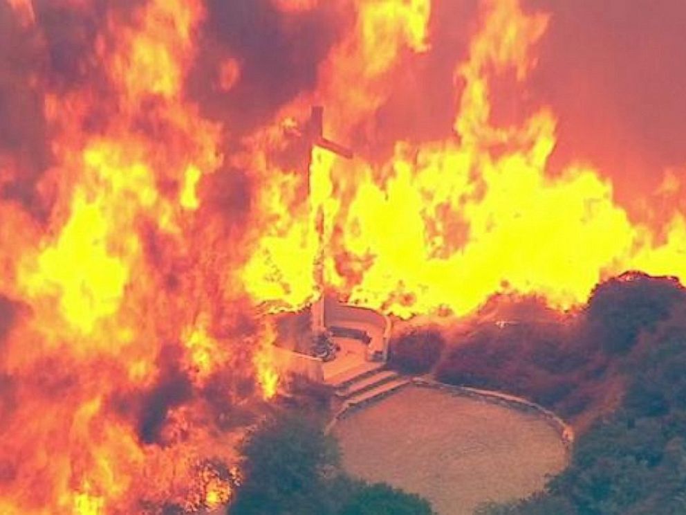 PHOTO: A cross burns in the Blue Cut Fire in the San Bernardino National Forest above Devore on Tuesday, Aug. 16, 2016.