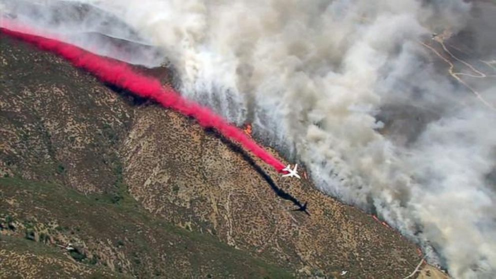 PHOTO: A plane drops fire retardant while battling the Blue Cut Fire in the San Bernardino National Forest on Tuesday, Aug. 16, 2016.