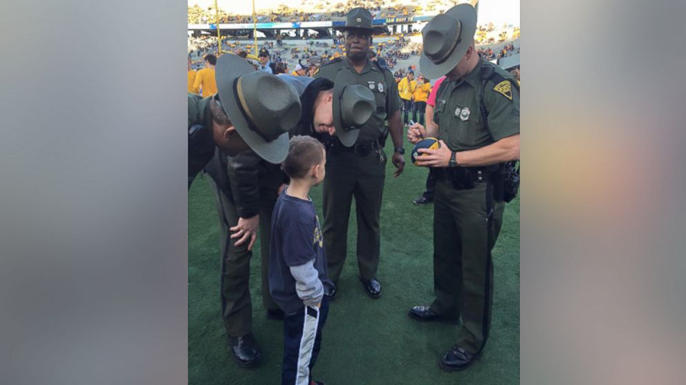 PHOTO:At a West Virginia University football game Saturday, 6-year-old Braedon Mullins asked state troopers to autograph his football instead of the football players. 