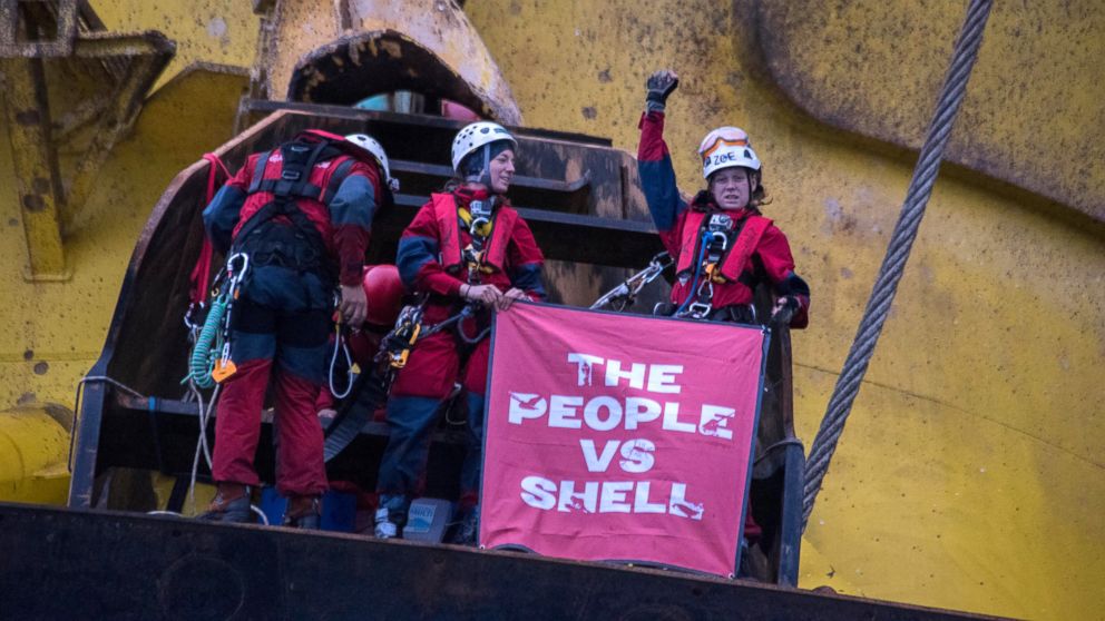PHOTO: Greenpeace activists hold a banner that reads 'The People vs. Shell' as they scaled the Polar Pioneer drill rig in the Pacific Ocean.