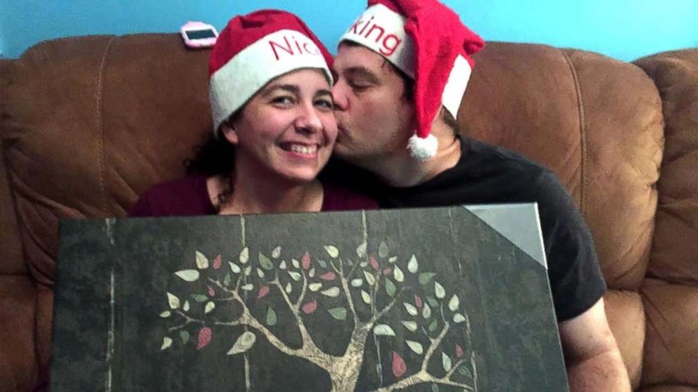 PHOTO: Hannah Overton and her husband hold up one of their Christmas presents.