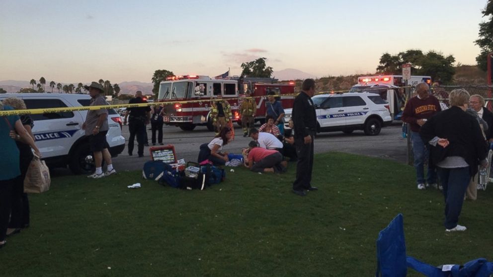 EMS personnel tend to concert-goers at the Irvine Meadows Amphitheatre in Irvine, California, on Sept. 8, 2016. A man in a vehicle caused a chain-reaction crash.