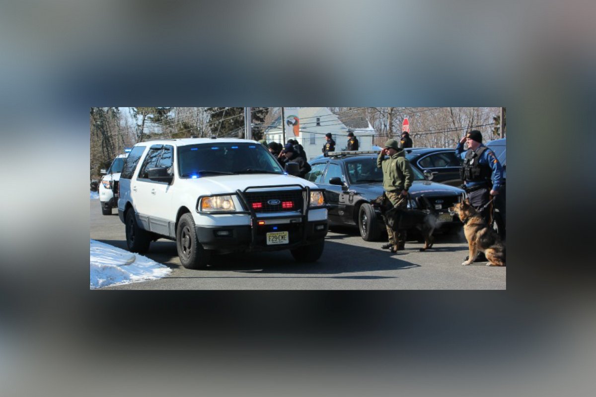 PHOTO: K-9 officers and their partners line the driveway of the Swedesboro Animal Hospital and salute as the small convoy with Mike Franks and Judge arrive.