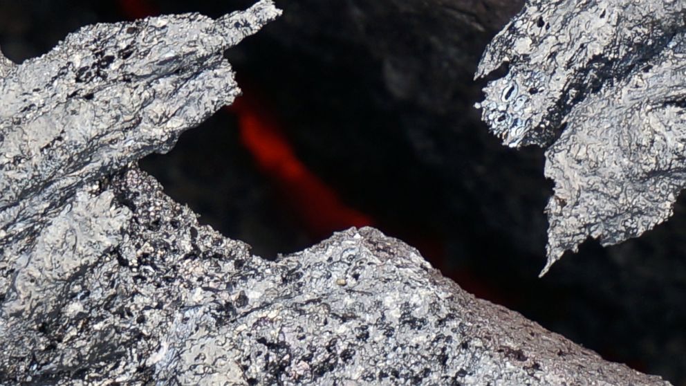 PHOTO:  Molten lava can be seen in between the cracks of these rocks in Hawaii.