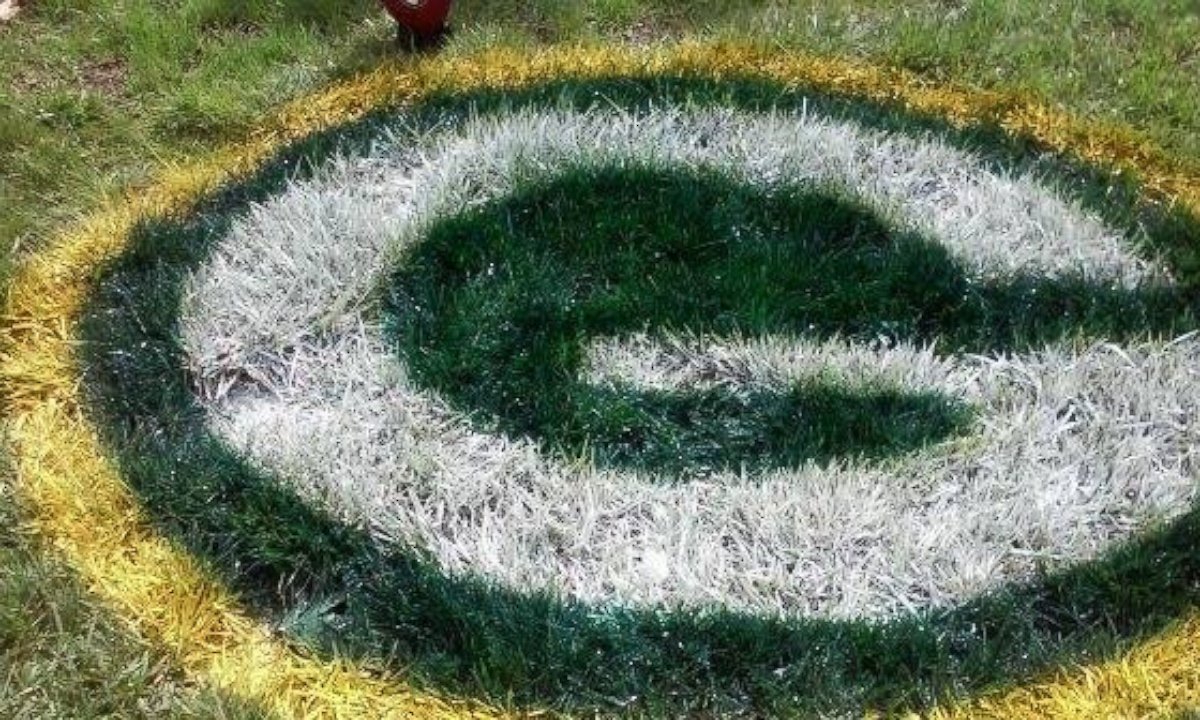 PHOTO: Fontana resident Randolph Phillips paints football logos on people's lawns.