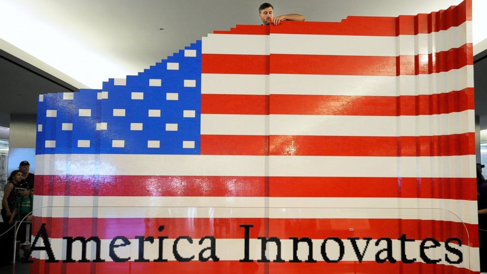 PHOTO: LEGO master builder Chris Steininger places a brick while building the world's largest LEGO American flag.