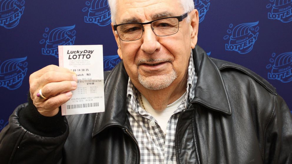 Martin Fuentes holds his $200,000 winning Luck Day Lotto ticket.