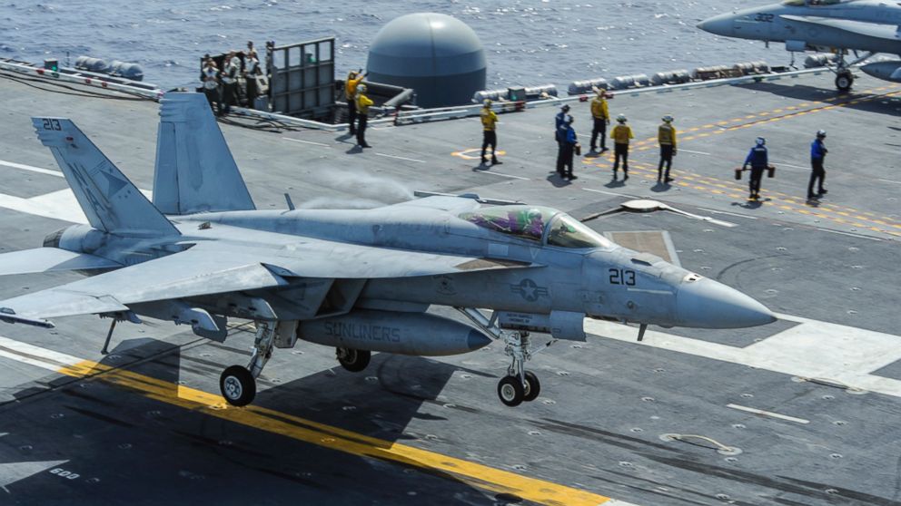 A file photo from the U.S. Navy shows an F/A-18E Super Hornet landing on the deck of the aircraft carrier USS Carl Vinson on Aug. 23, 2014.