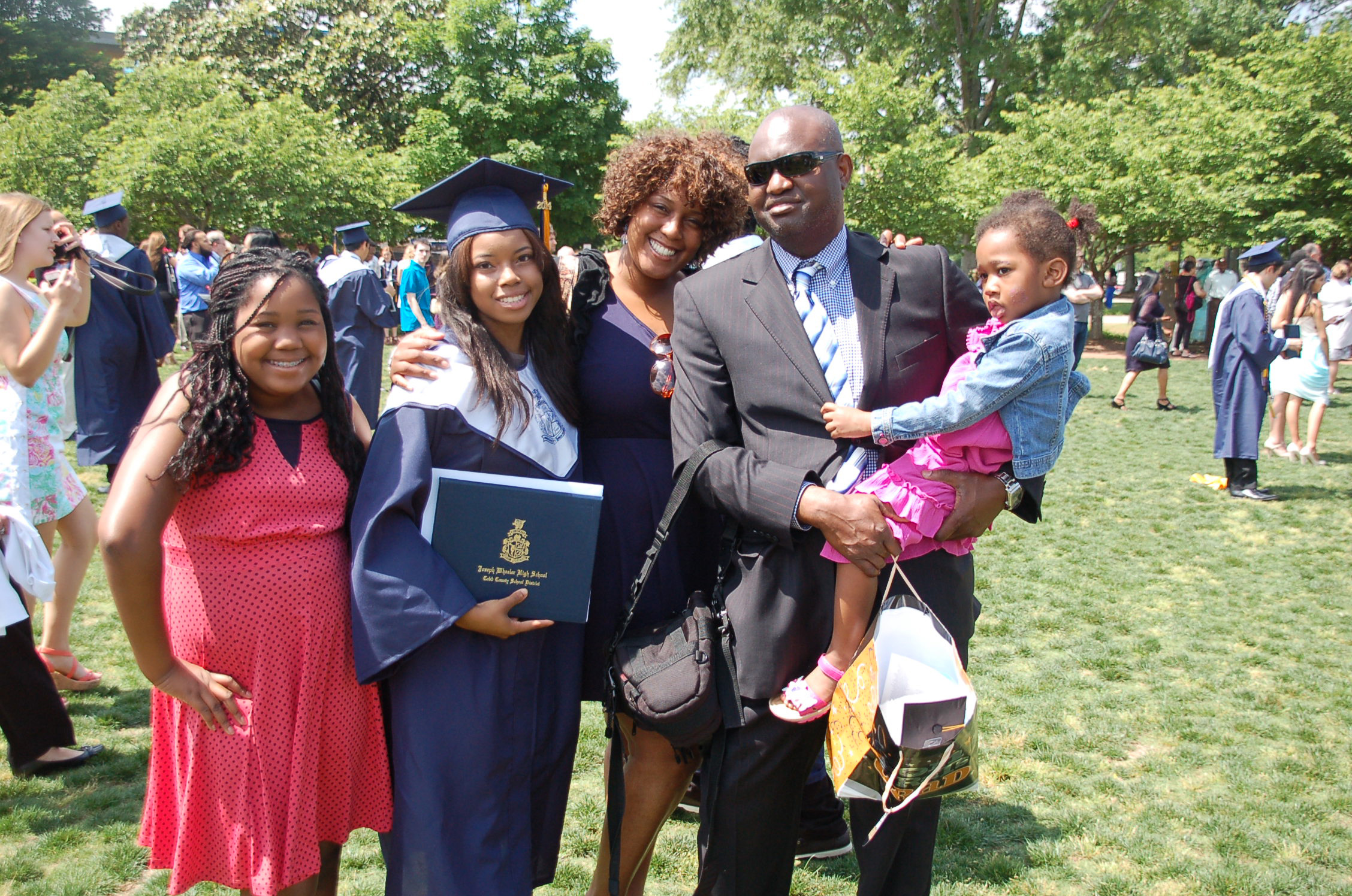 PHOTO: Melisa Alaba with her children and husband at her oldest daughter’s high school graduation in May 2014. 
