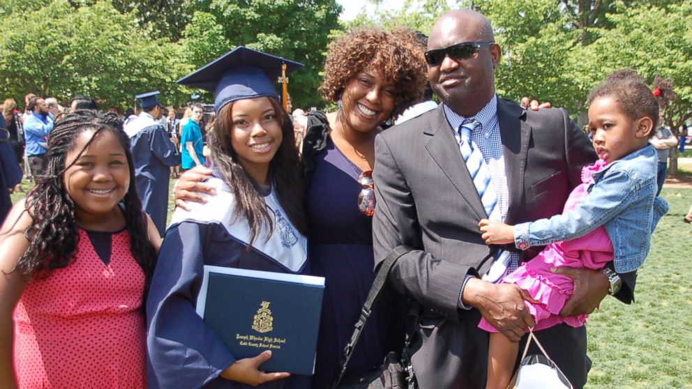 PHOTO: Melisa Alaba with her children and husband at her oldest daughter’s high school graduation in May 2014. 